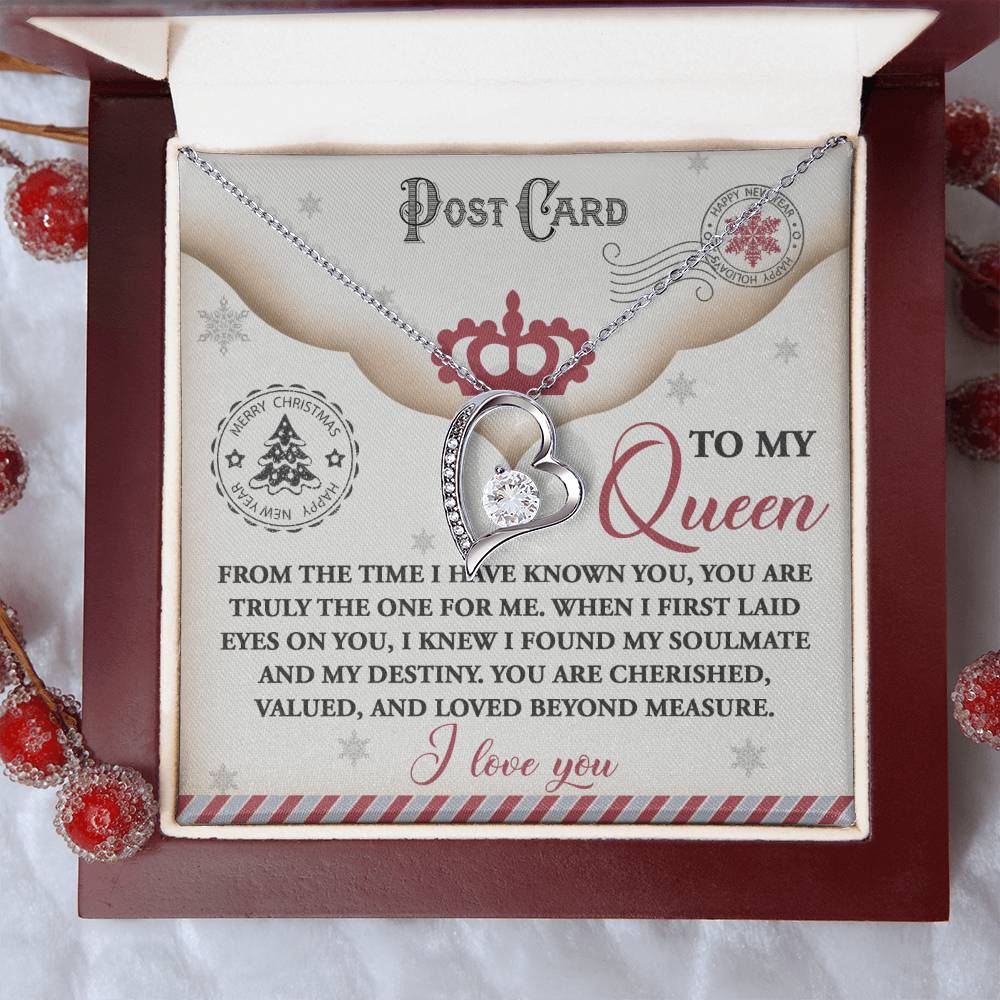 The Soulmate-The One - Forever Love Necklace, elegantly designed with a gold finish and embellished with cubic zirconia, is presented in a box adorned with red berries. Inside the box, a heartfelt message that reads "To my Queen" conveys deep and steadfast love.