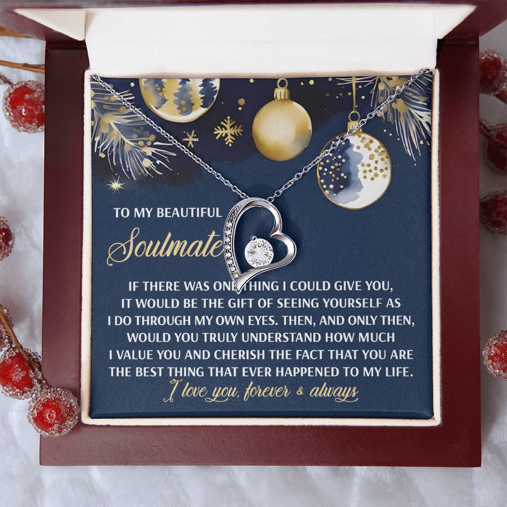 The Soulmate-One Thing - Forever Love Necklace, featuring a heart-shaped charm and sparkling cubic zirconia, is gracefully presented over a card with a romantic message surrounded by holiday-themed decorations.