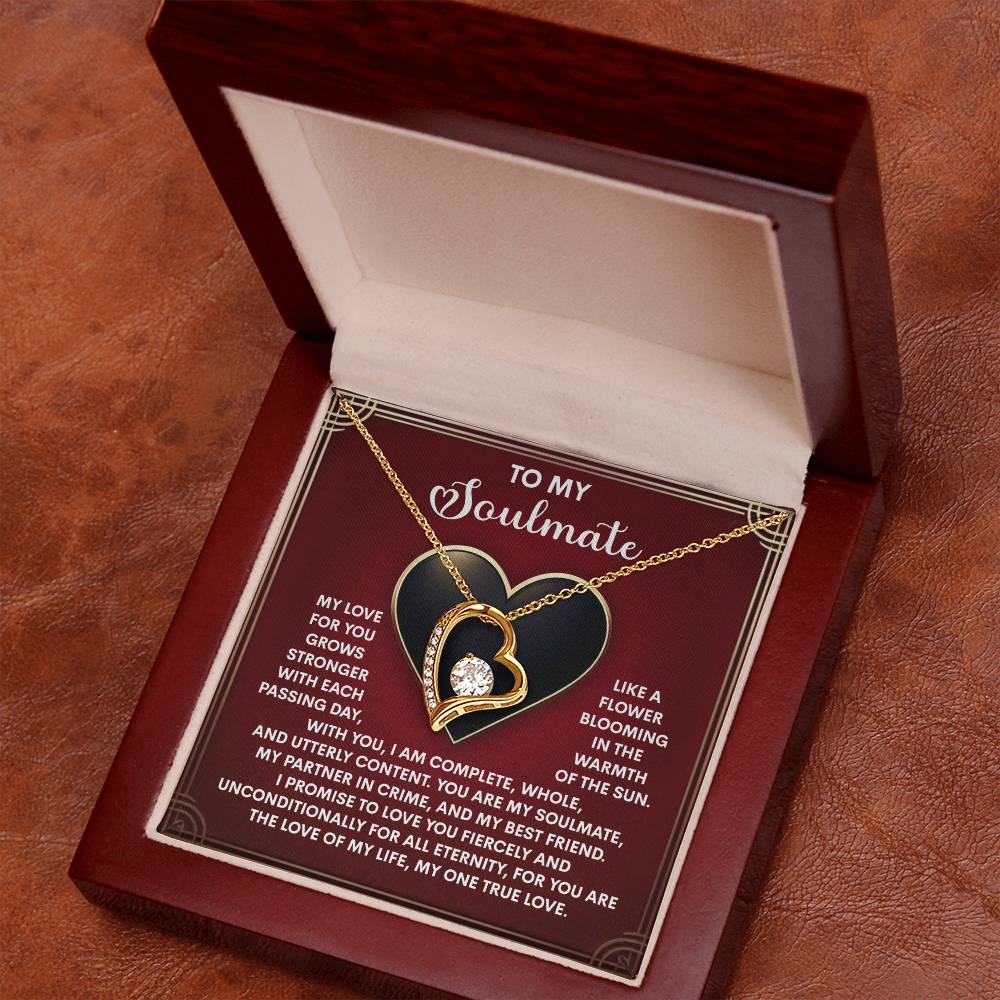 The Soulmate-One True Love - Forever Love Necklace showcases intertwined hearts with a sparkling cubic zirconia, presented in a wooden box. Available in white or yellow gold finish, it includes a romantic message for your soulmate.