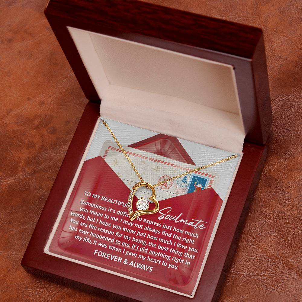 The Soulmate-Right Words - Forever Love Necklace, showcasing a stunning heart-shaped pendant embellished with a CZ crystal, is presented in an open wooden box. It also comes with a touching message card and a red envelope inside.