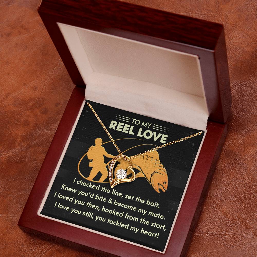 The Soulmate-Tackled My Heart - Forever Love Necklace with a heart pendant adorned with shimmering CZ crystals is displayed in an open wooden jewelry box, featuring a card with a fishing-themed romantic message that perfectly captures the essence of love.