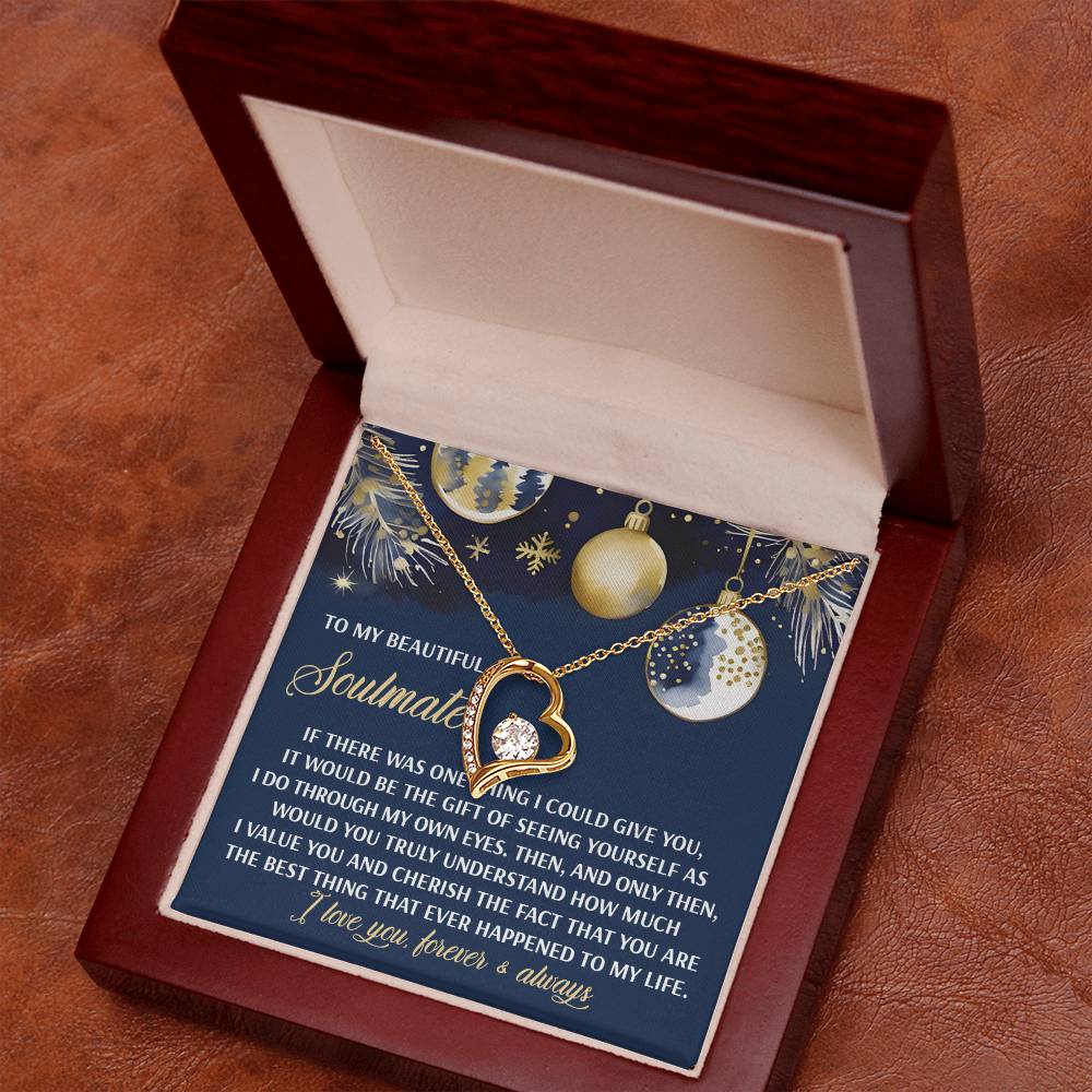 The Soulmate-One Thing - Forever Love Necklace, featuring a gold finish and a sparkling cubic zirconia gem, is elegantly presented in an open wooden box. The lid of the box carries a heartfelt message, complemented by an ornament-adorned festive background.