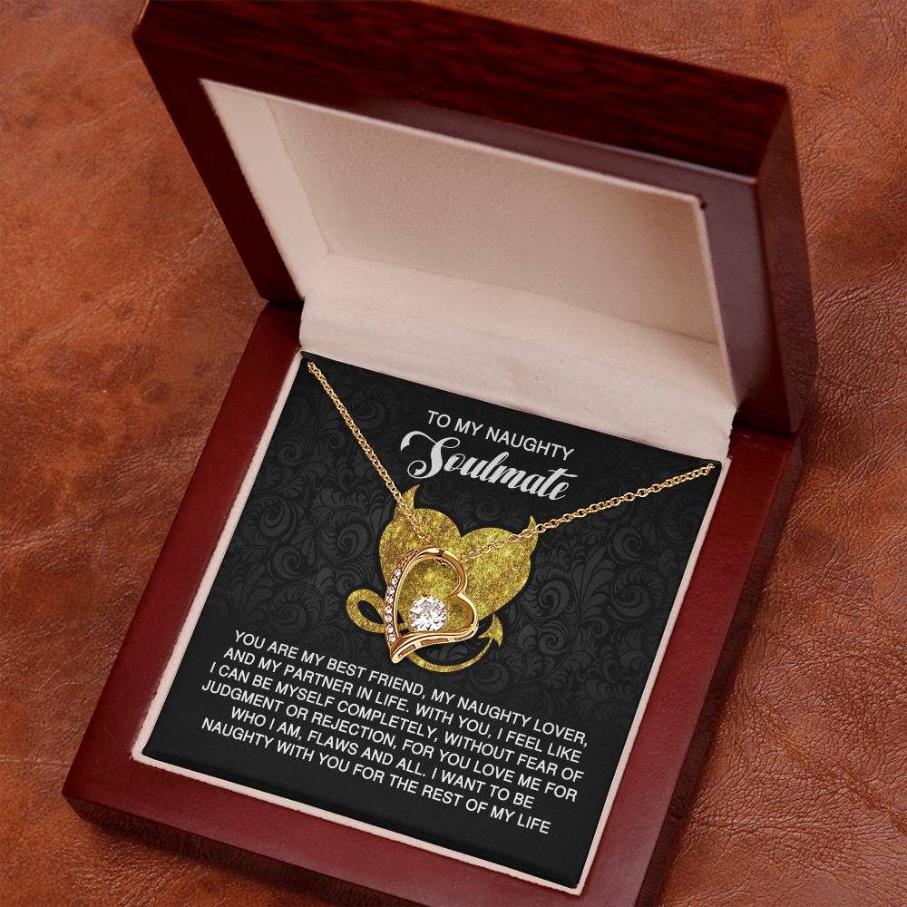 The Soulmate-Naughty With You - Forever Love Necklace, featuring heart and leaf pendants with cubic zirconia stones, is beautifully presented in a wooden box with a card that reads "To My Naughty Soulmate," adorning the brown surface.