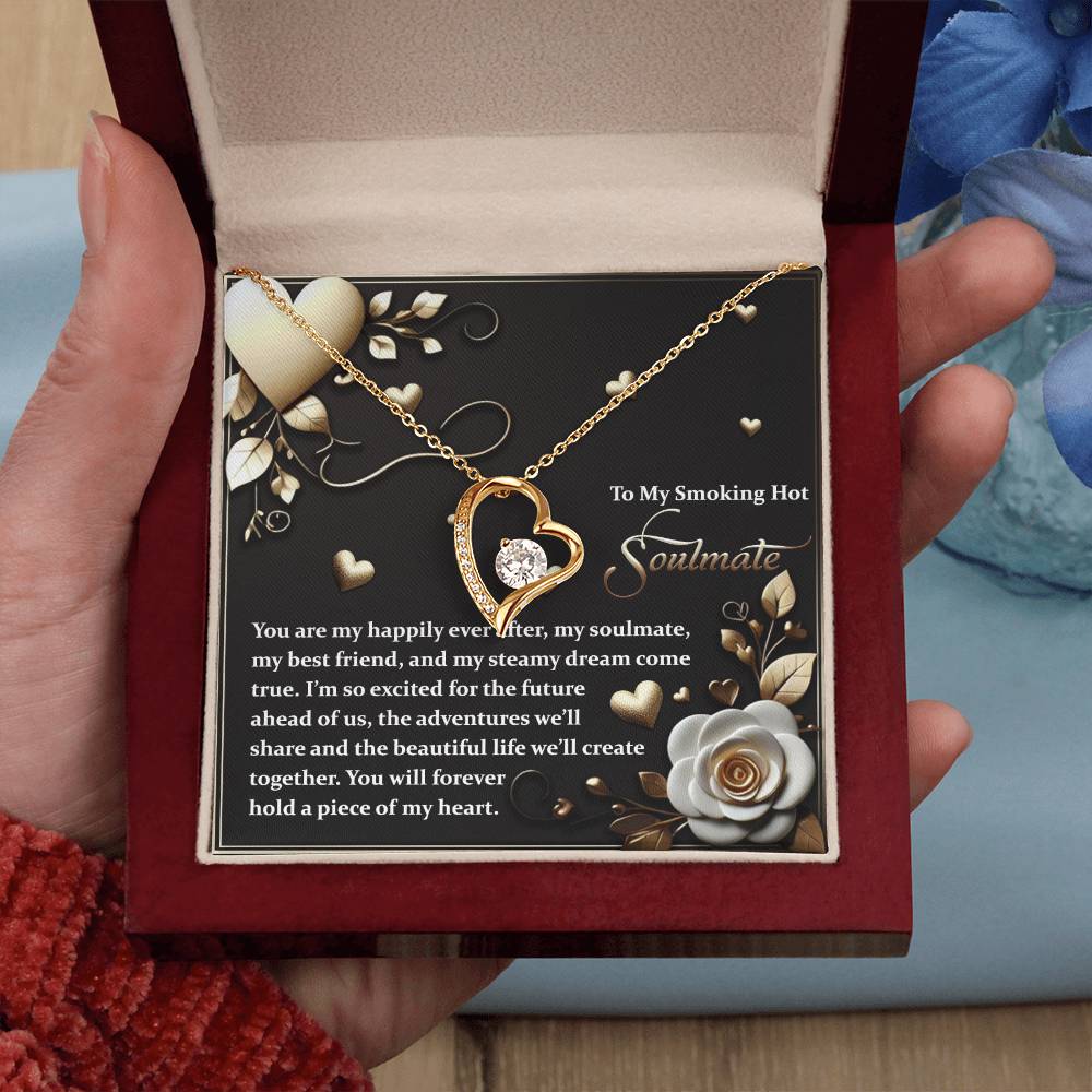 A Soulmate-The Future - Forever Love Necklace with a diamond center, elegantly gold-finished, rests in an open box surrounded by roses and a heartfelt message.