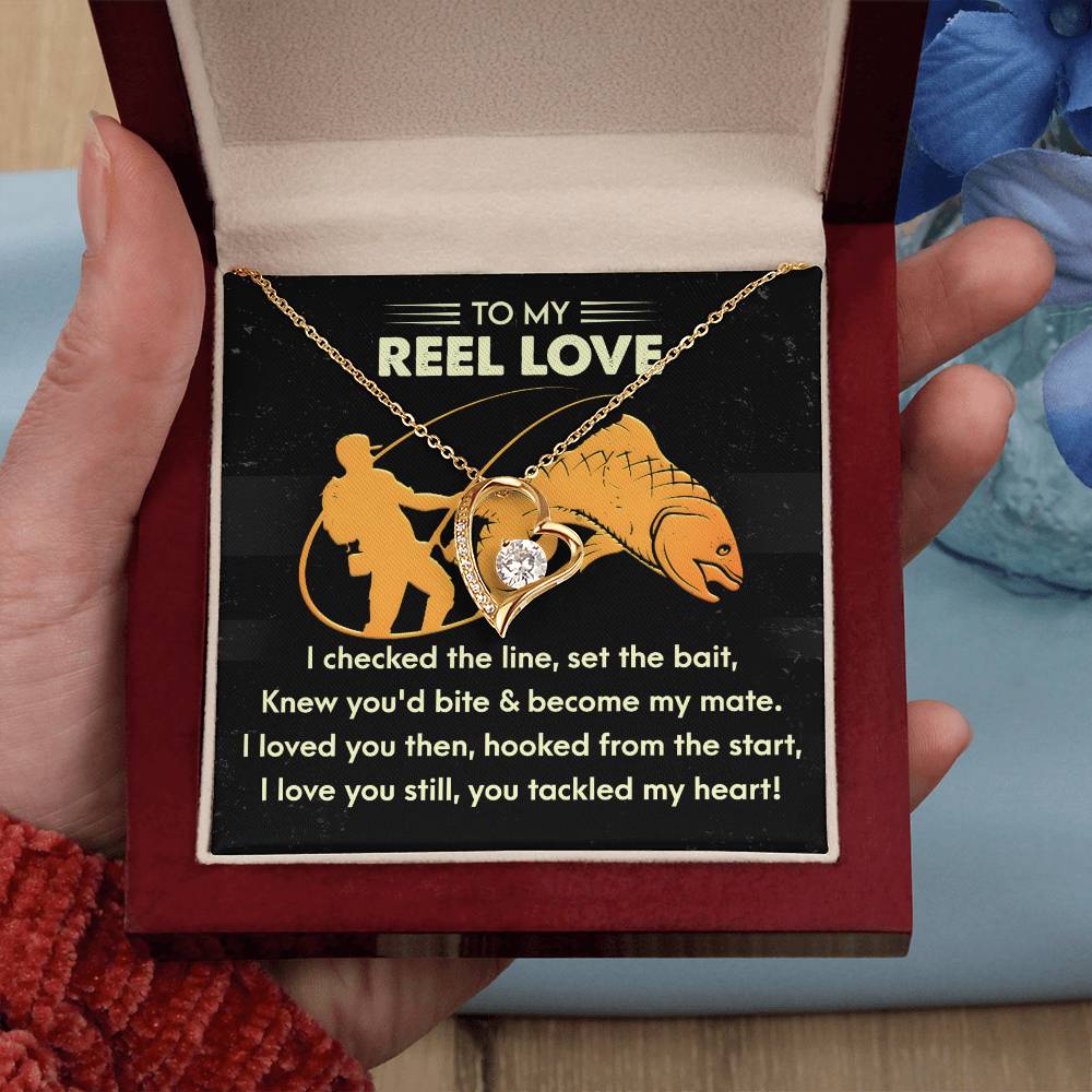 Open jewelry box to reveal the Soulmate-Tackled My Heart - Forever Love Necklace, featuring a stunning gold finish and a fishing-themed love message card adorned with sparkling CZ crystals.