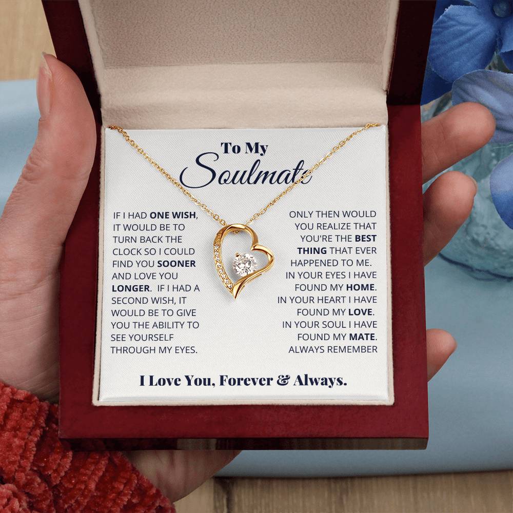 A person holding a gift box with a To My Soulmate, I Love You, Forever & Always - Forever Love Necklace featuring a heart-shaped cubic zirconia pendant and a message to a soulmate from ShineOn Fulfillment.