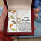 A hand holds an open gift box revealing the Daughter-Biggest Fan - Forever Love Necklace featuring a heart pendant. Accompanying text reads "To My Daughter" alongside a heartfelt message inside, emphasizing the sparkling CZ crystal set in a stunning gold finish.