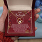 A hand holds an open gift box, revealing a gorgeous Forever Love Necklace and a heartfelt message—a perfect gift for your soulmate.