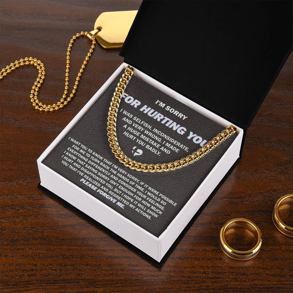 The "Sorry, Hurt You Badly - Cuban Link Chain," crafted in 14K yellow gold, is elegantly presented on a black gift box. The box features an apology message printed in white text, expressing regret for selfish actions, acknowledging wrongdoing, and asking for forgiveness.