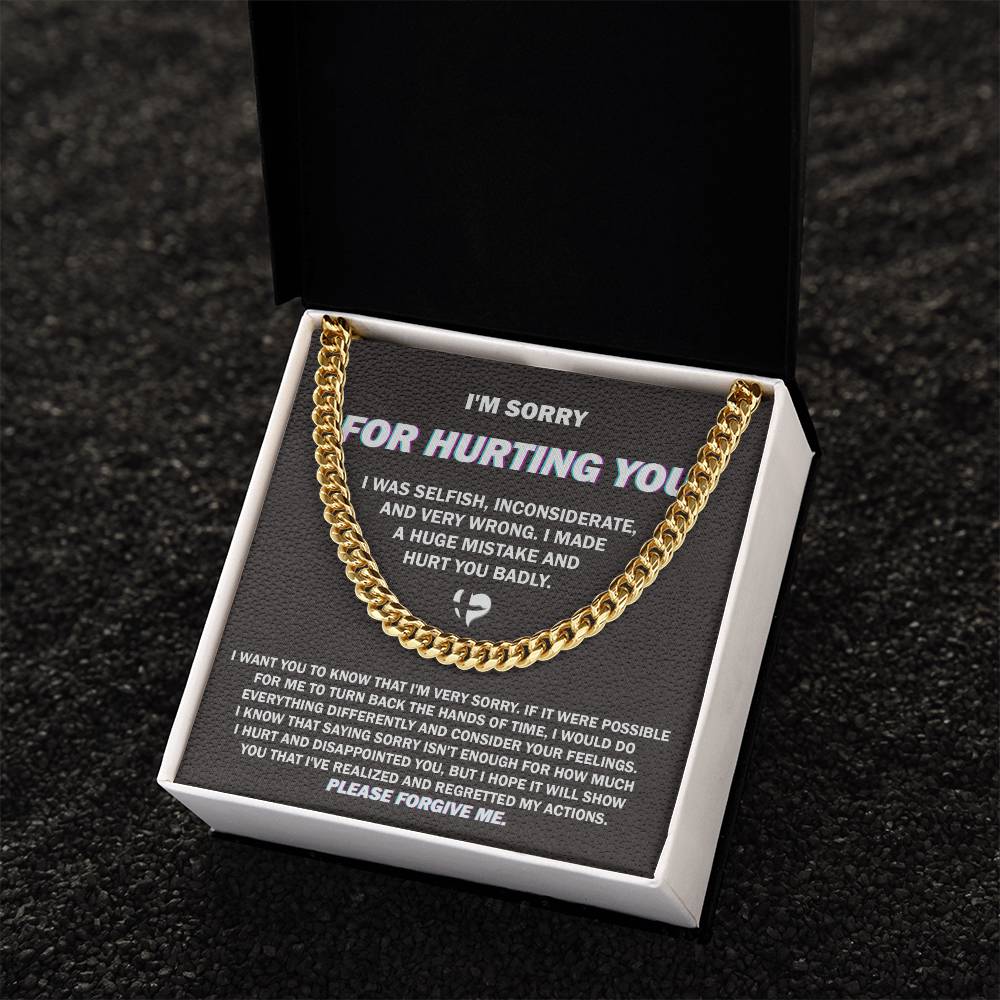 The "Sorry, Hurt You Badly - Cuban Link Chain," crafted in 14K yellow gold, is elegantly presented on a black gift box. The box features an apology message printed in white text, expressing regret for selfish actions, acknowledging wrongdoing, and asking for forgiveness.