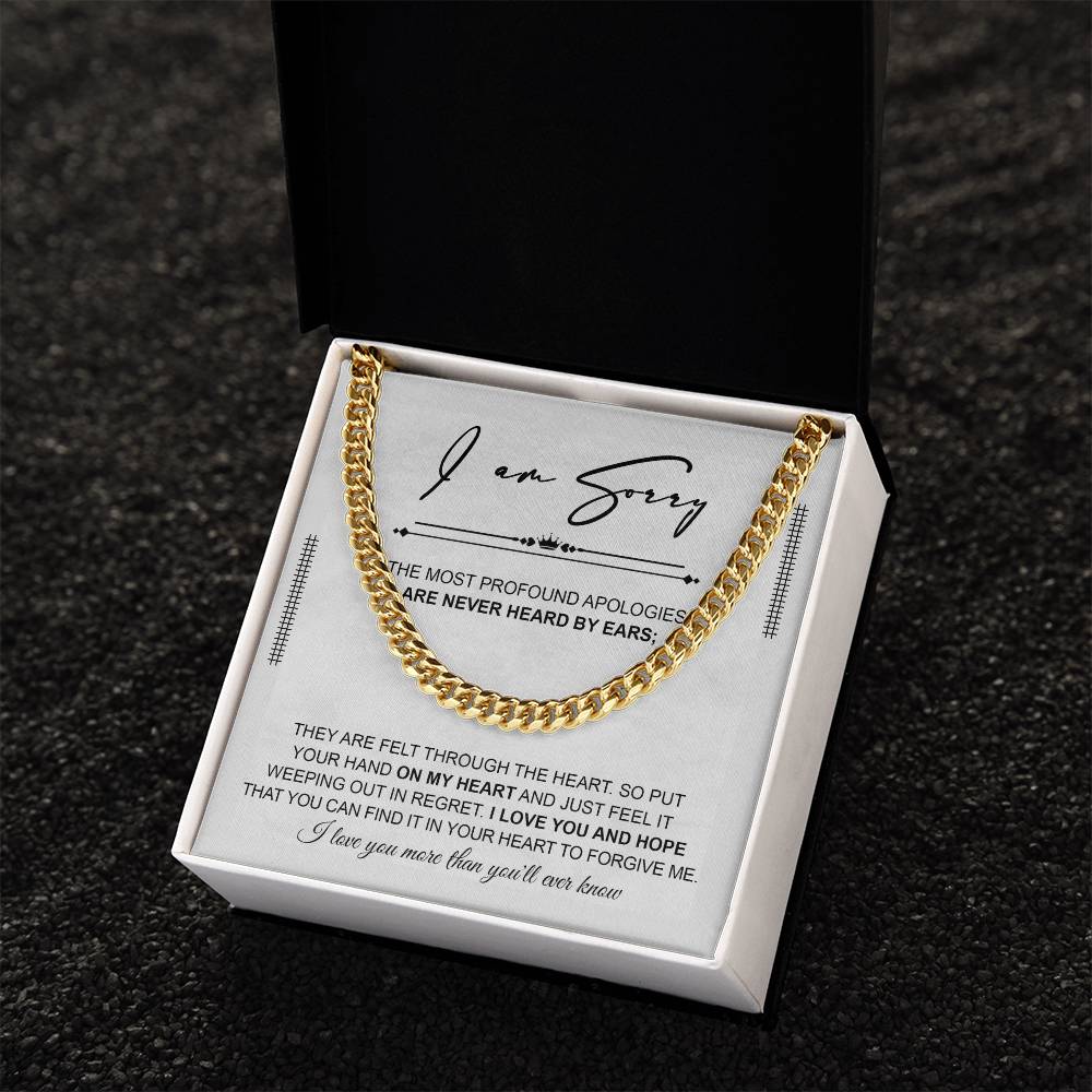 A polished stainless steel Cuban Link Chain necklace with an apology note. The note reads: "I am sorry. The most profound apologies are never heard by ears; they are felt through the heart... I love you and hope you can forgive me.