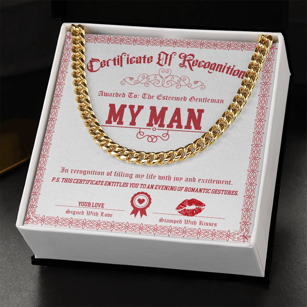 A polished stainless steel Cuban Link Chain from the "My Man-Esteemed Gentleman" collection is displayed on a red and white "Certificate of Recognition" for "My Man" in a box.