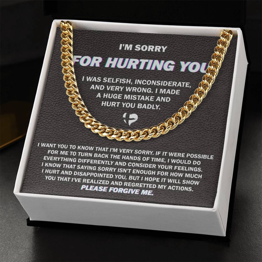 The "Sorry, Hurt You Badly - Cuban Link Chain," crafted in 14K yellow gold, is elegantly presented on a black gift box. The box features an apology message printed in white text, expressing regret for selfish actions, acknowledging wrongdoing, and asking for forgiveness.