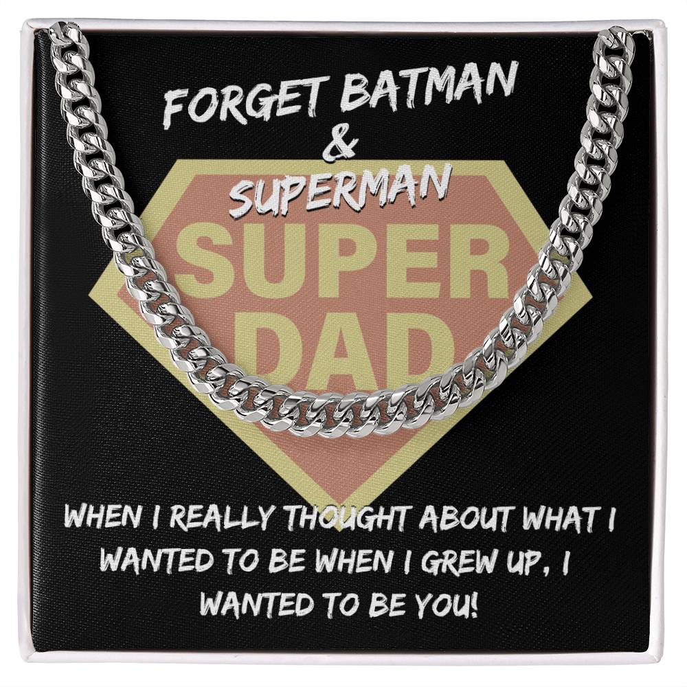 "To Dad, To Be You" emblem resembling a superhero logo, framed by a Cuban link chain, with the text "forget batman & superman, when I really thought about what i wanted to be when I