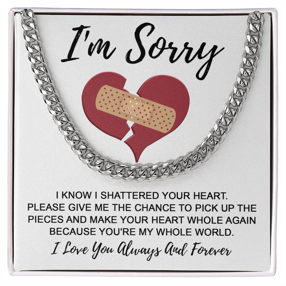 The Sorry-The Pieces - Cuban Link Chain is a necklace showcased with an apology note, featuring a broken heart with a bandage and the inscriptions "I'm Sorry" and "I Love You Always And Forever," skillfully crafted from polished stainless steel with an adjustable length for a perfect fit.