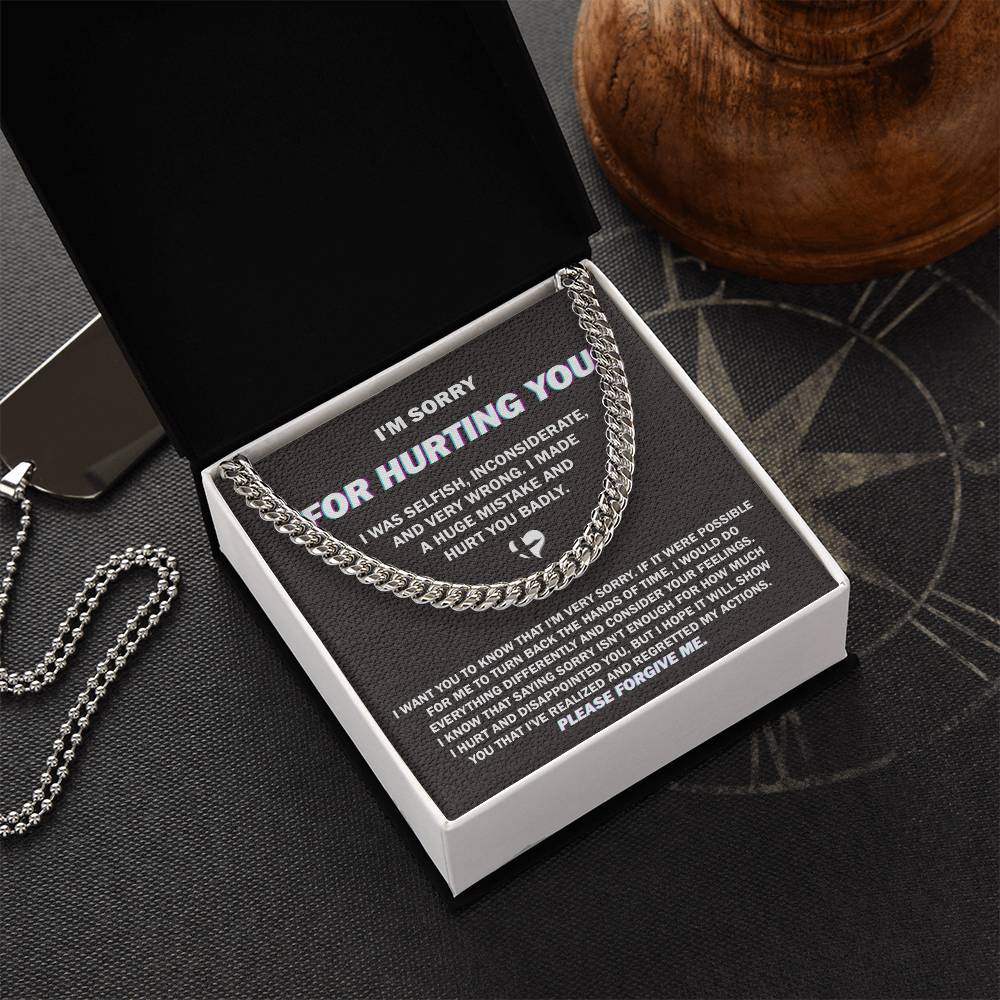 The "Sorry, Hurt You Badly - Cuban Link Chain," crafted in 14K yellow gold, is elegantly presented on a black gift box. The box features an apology message printed in white text, expressing regret for selfish actions, acknowledging wrongdoing, and asking for forgiveness.