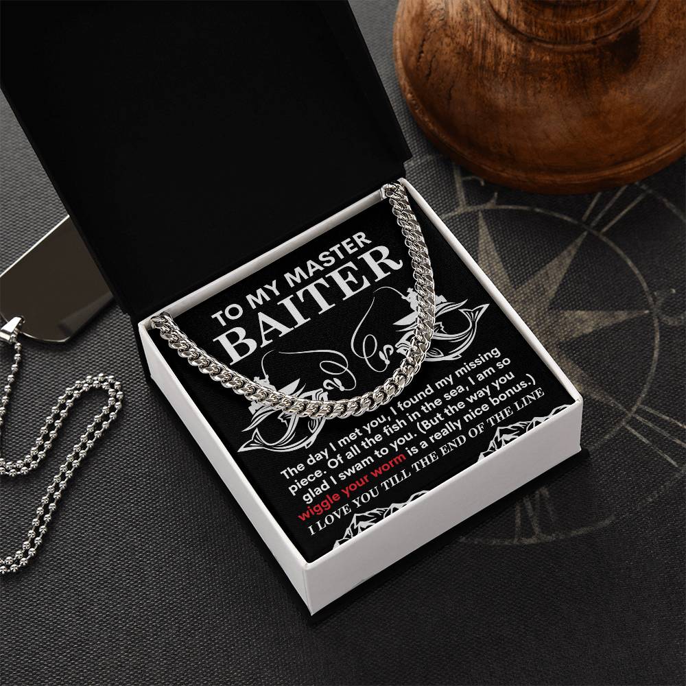 A polished "My Man-In The Sea" Cuban link chain sits elegantly in an open black box with decorative text, featuring the phrase "TO MY MASTER BAITER" and a heartfelt message.