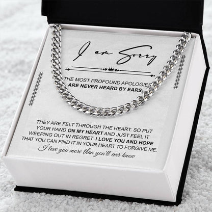 A polished stainless steel Cuban Link Chain necklace with an apology note. The note reads: "I am sorry. The most profound apologies are never heard by ears; they are felt through the heart... I love you and hope you can forgive me.