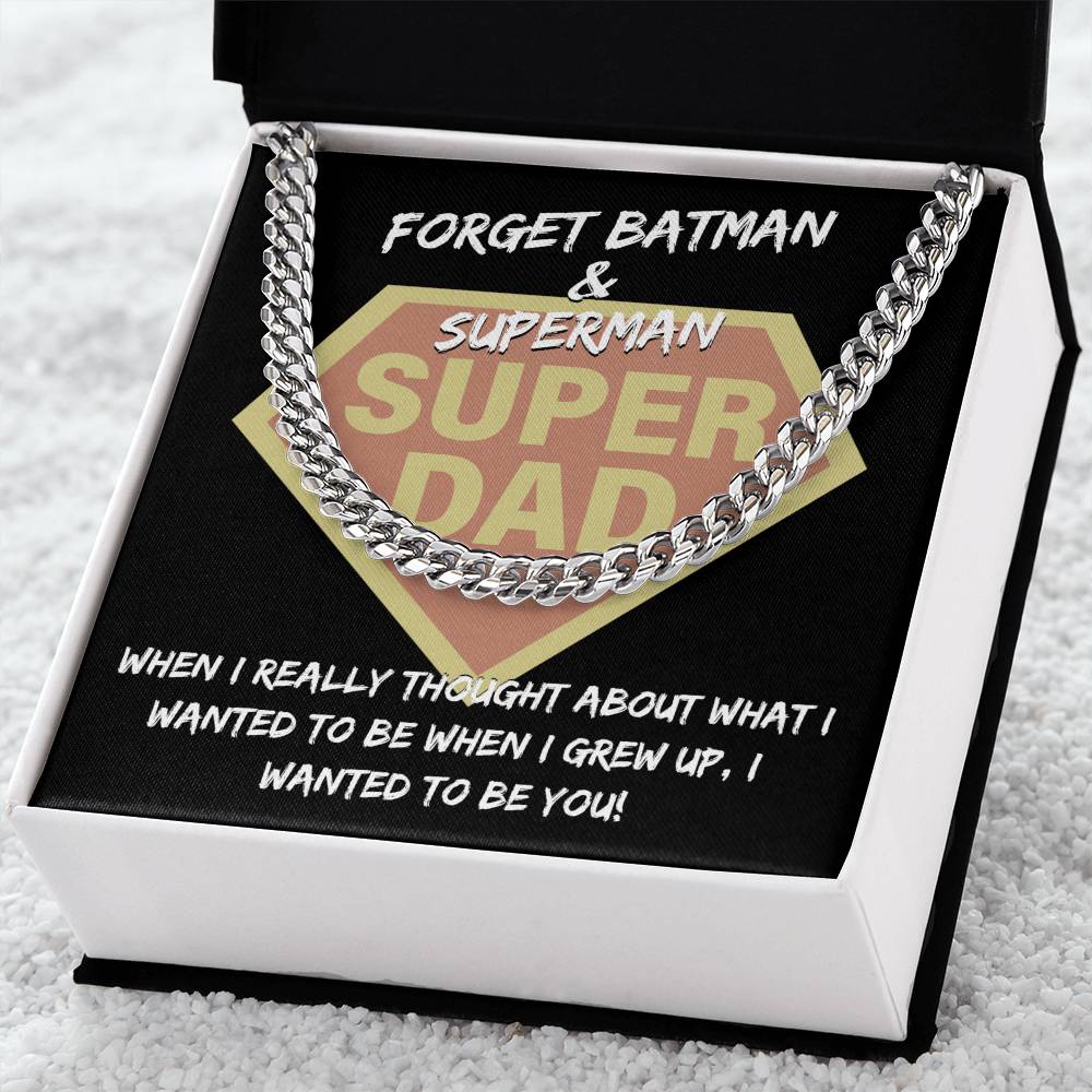 "To Dad, To Be You" emblem resembling a superhero logo, framed by a Cuban link chain, with the text "forget batman & superman, when I really thought about what i wanted to be when I