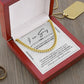 A 14K yellow gold "Sorry-Out In Regret - Cuban Link Chain" necklace sits in an open red velvet box with an apology card. Beside it, a gold pendant necklace and ring elegantly complement the design.