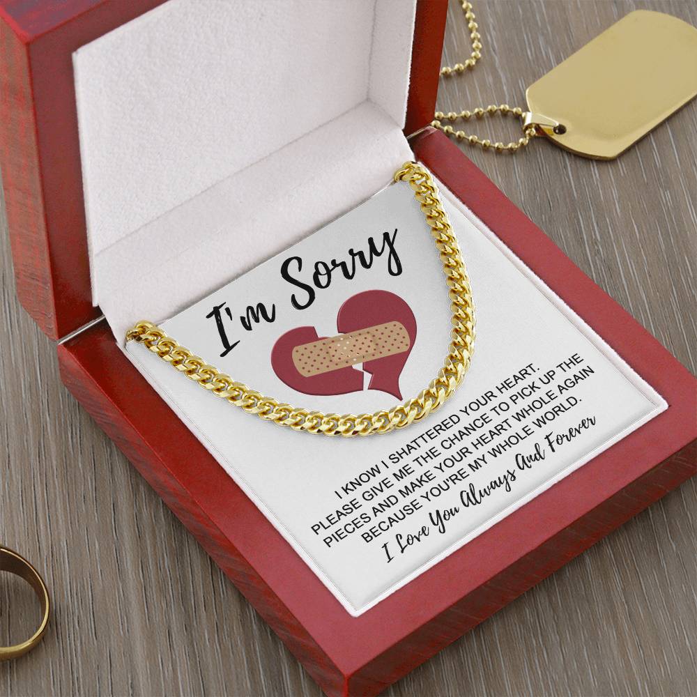 A Sorry-The Pieces - Cuban Link Chain necklace in a red box with an apology card, featuring a broken heart with a band-aid and the message, "I'm Sorry. I love you always and forever.