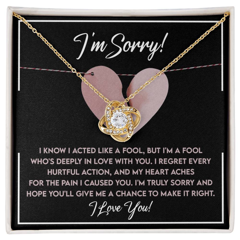 A personalized gift, this Sorry-Deeply In Love - Love Knot Necklace with a pendant is presented on a display card that reads, "I'm Sorry," followed by a heartfelt apology message and "I Love You!" at the bottom. The pendant is elegantly adorned with sparkling cubic zirconia crystals.