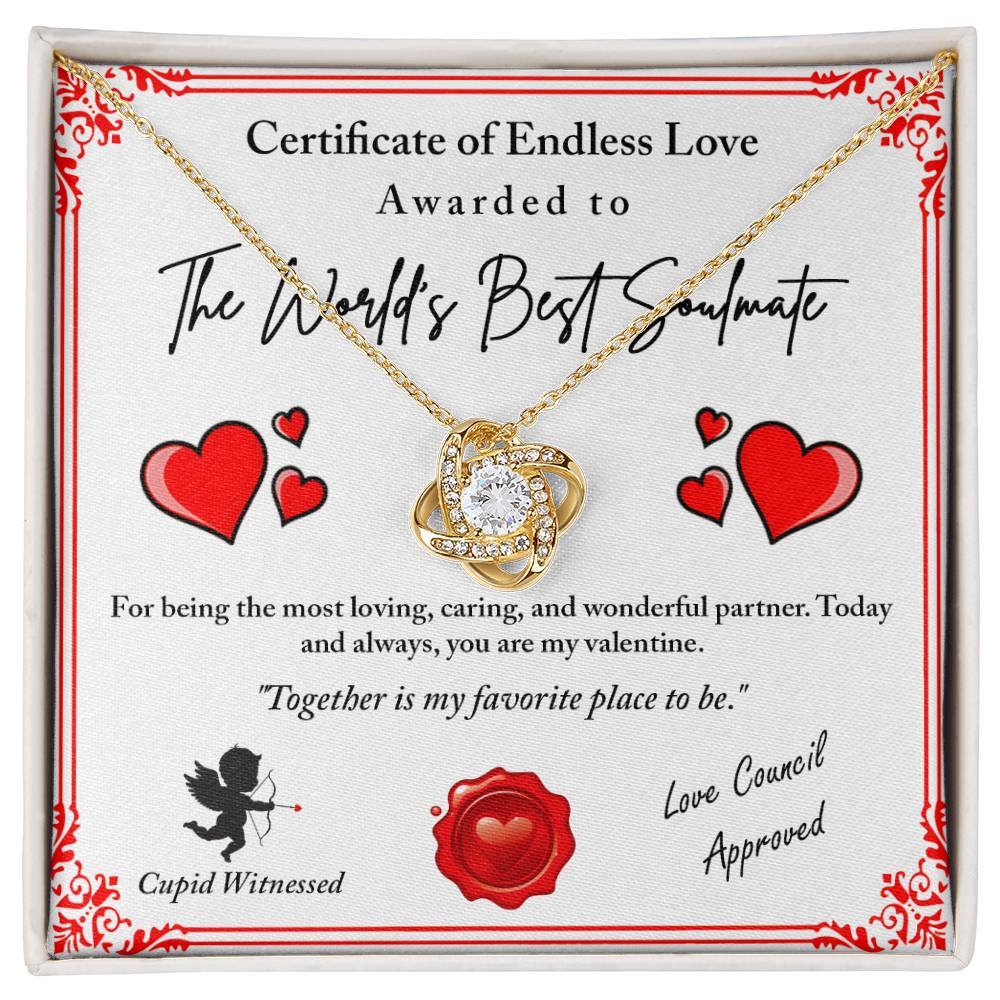 The Love Certificate-Cupid Witnessed - Love Knot Necklace features a gold heart-shaped design with cubic zirconia crystals. It includes a heartfelt message: "Certificate of Endless Love, Awarded to The World's Best Soulmate," adorned with hearts and a Cupid icon—an ideal way to express true devotion.