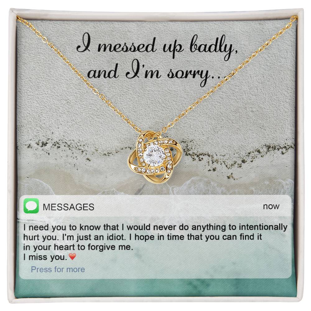 The "Sorry-Just An Idiot - Love Knot Necklace" features a heart-shaped pendant adorned with cubic zirconia crystals, presented on a card inscribed with "I messed up badly, and I'm sorry." It comes complete with a heartfelt text message expressing deep remorse and seeking forgiveness.