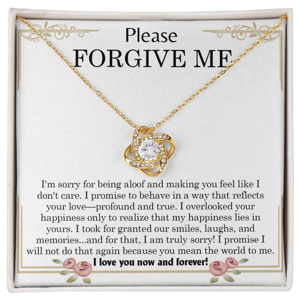 The "Sorry, Profound And True - Love Knot Necklace," featuring an intertwined heart pendant, is elegantly displayed in a box. The message "Please FORGIVE ME!" along with a heartfelt apology note is printed inside the box and beautifully accentuated by cubic zirconia crystals.