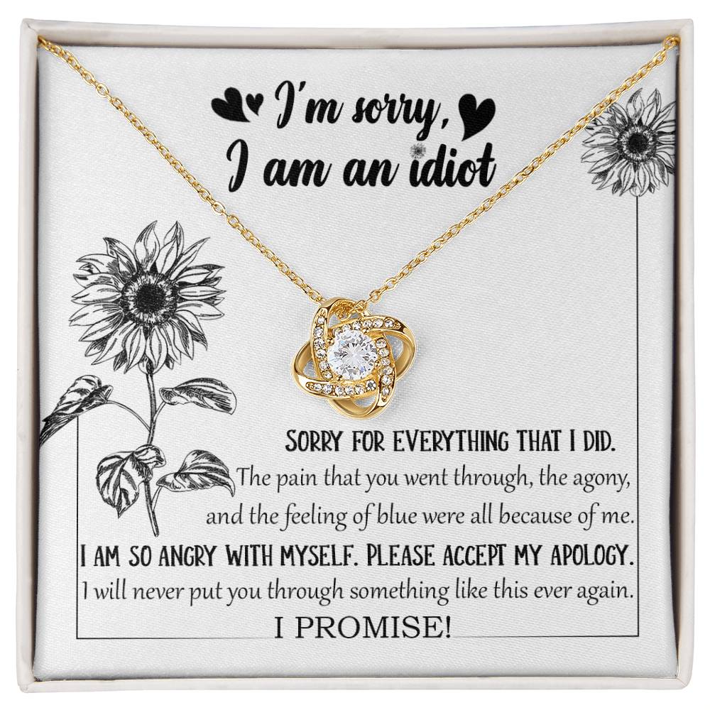 The Sorry-Feeling Of Blue - Love Knot Necklace, crafted from 14k white gold with a heart-shaped pendant adorned with cubic zirconia crystals, is displayed in a box containing an apology message, "I'm sorry, I am an idiot," along with additional text expressing regret for causing pain and a promise to not repeat the hurt.