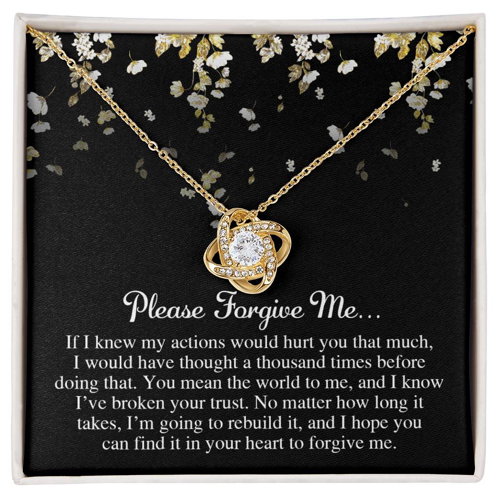 Displayed is the "Sorry-Broken Your Trust - Love Knot Necklace," featuring a pendant with intertwined loops and a central gem. The background includes an elegant floral design and a heartfelt apology message starting with "Please Forgive Me." Adorned with cubic zirconia crystals, this personalized gift speaks volumes.