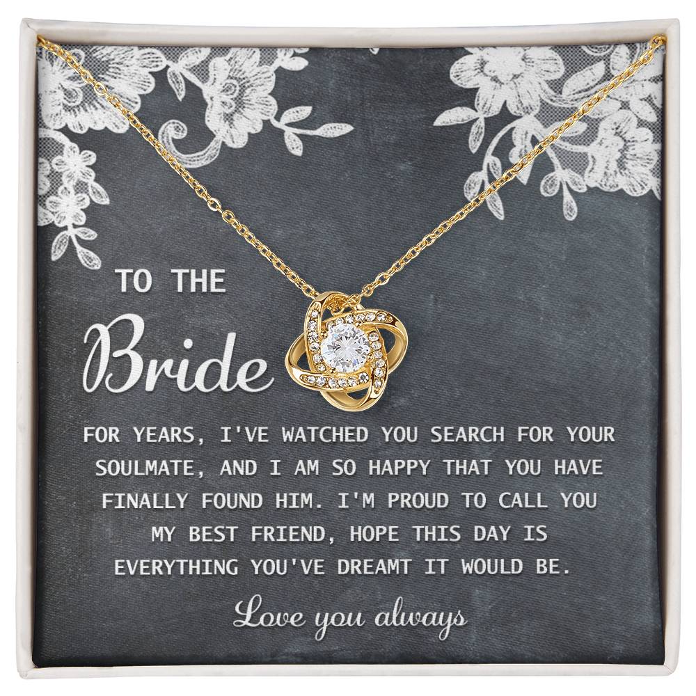 The "To Bride, My Best Friend - Love Knot Necklace" in silver, adorned with cubic zirconia crystals, is presented on a card with a sentimental message for the bride and comes in a decorated gift box.