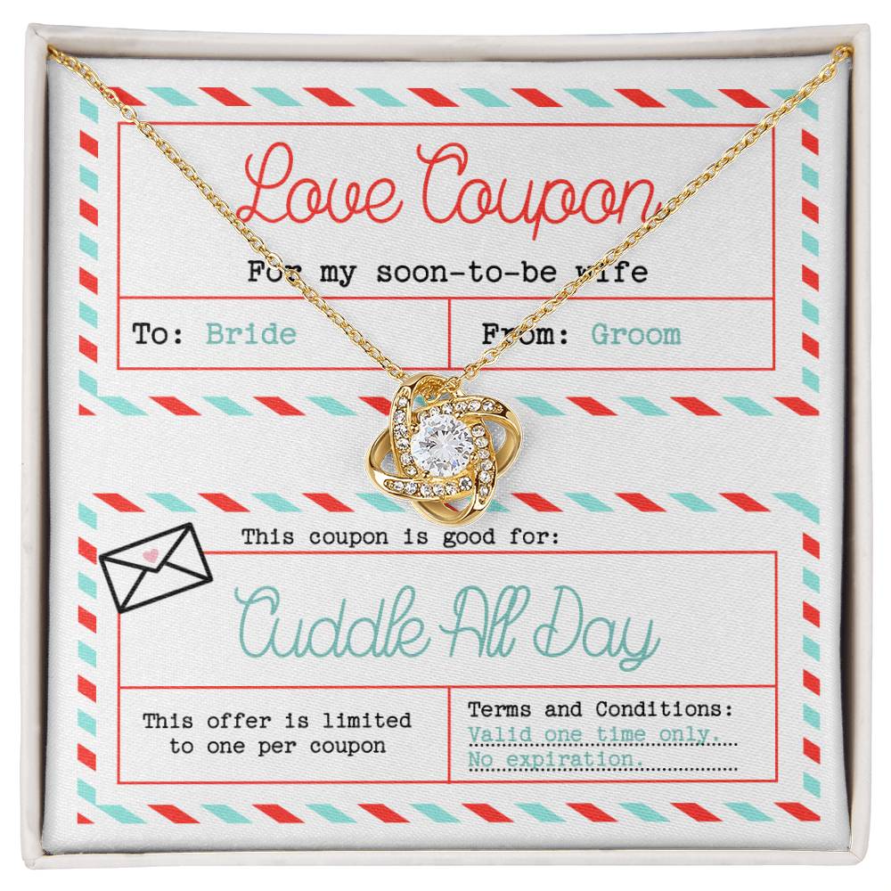 The "To Wife, Wedding-Love Coupon - Love Knot Necklace" adorned with cubic zirconia crystals sits atop a decorated card labeled "Love Coupon." The card, addressed to "Bride" from "Groom," offers a "Cuddle All Day" coupon with no expiration date—a perfect gift for a loved one.