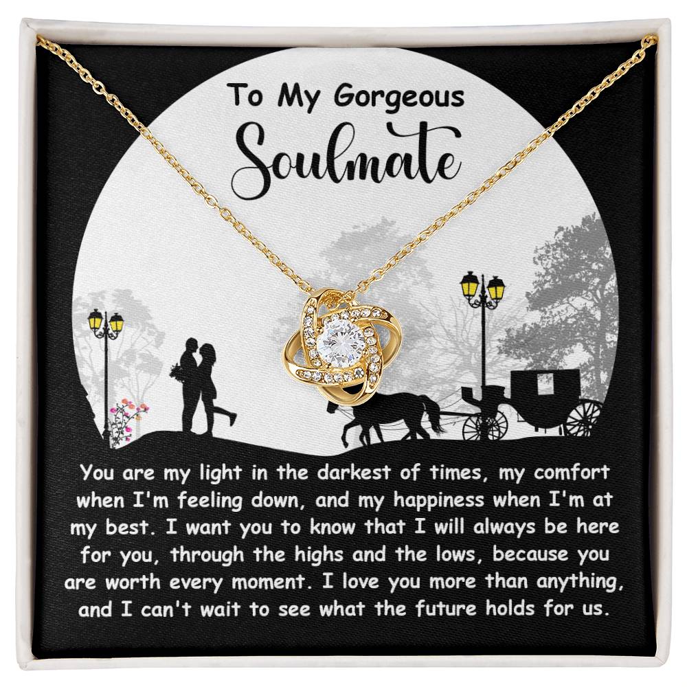 The Soulmate-Holds For Us - Love Knot Necklace showcases a heart-shaped pendant with sparkling cubic zirconia, set against a card with a romantic silhouette and message of love for your soulmate, making it the perfect personalized gift for your beloved.