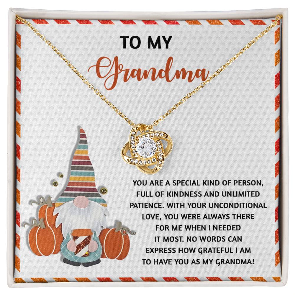 This custom gift, the "Grandma-Needed It Most" Love Knot Necklace embellished with cubic zirconia, is presented on a touching card that expresses gratitude for grandma and showcases an adorable gnome with pumpkins.