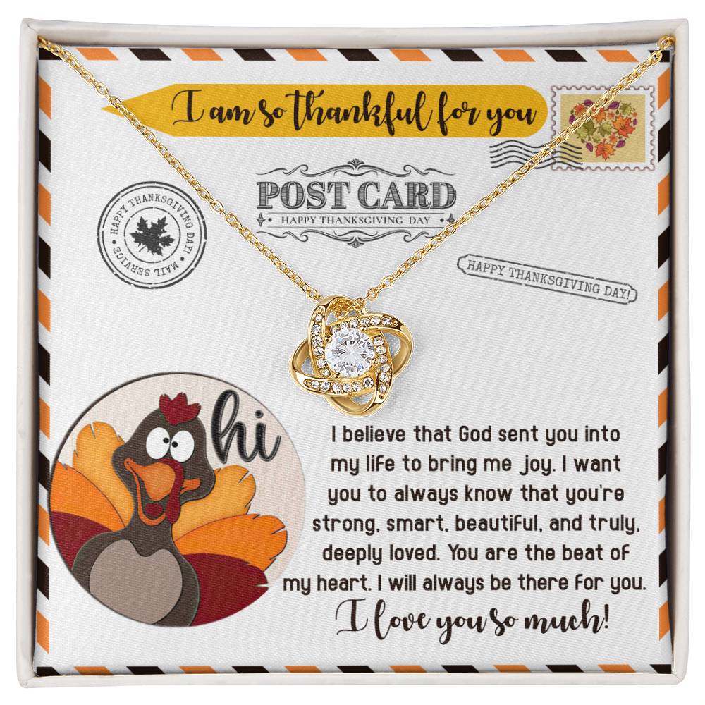 Thanksgiving-The Beat - Love Knot Necklace presented in a gift box, featuring a gold finish and accompanied by a Thanksgiving-themed message with a cartoon turkey and touching words about love and gratitude.