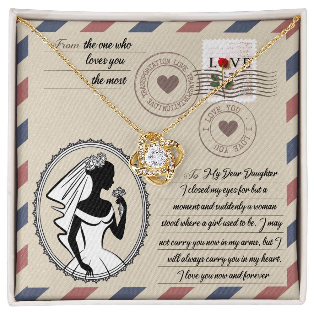 A To Daughter Wedding, In My Arms - Love Knot Necklace with a heart-shaped pendant on a card with a vintage design, featuring cubic zirconia crystals, a silhouette of a woman in a wedding gown, and a heartfelt message addressed to a daughter.