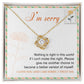 The "Sorry, Another Chance - Love Knot Necklace," featuring sparkling cubic zirconia crystals and crafted in 14k white gold, rests in a box. A note inside reads, "I'm sorry. Nothing is right in this world if I can't make this right. Please give me another chance to become a better version of myself. I love you and I am sorry, I truly am.