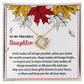 The Daughter-Fill Your Life - Love Knot Necklace features a heart-shaped pendant adorned with cubic zirconia crystals, displayed on a card with an autumn leaf design and a heartfelt message addressed to a daughter.