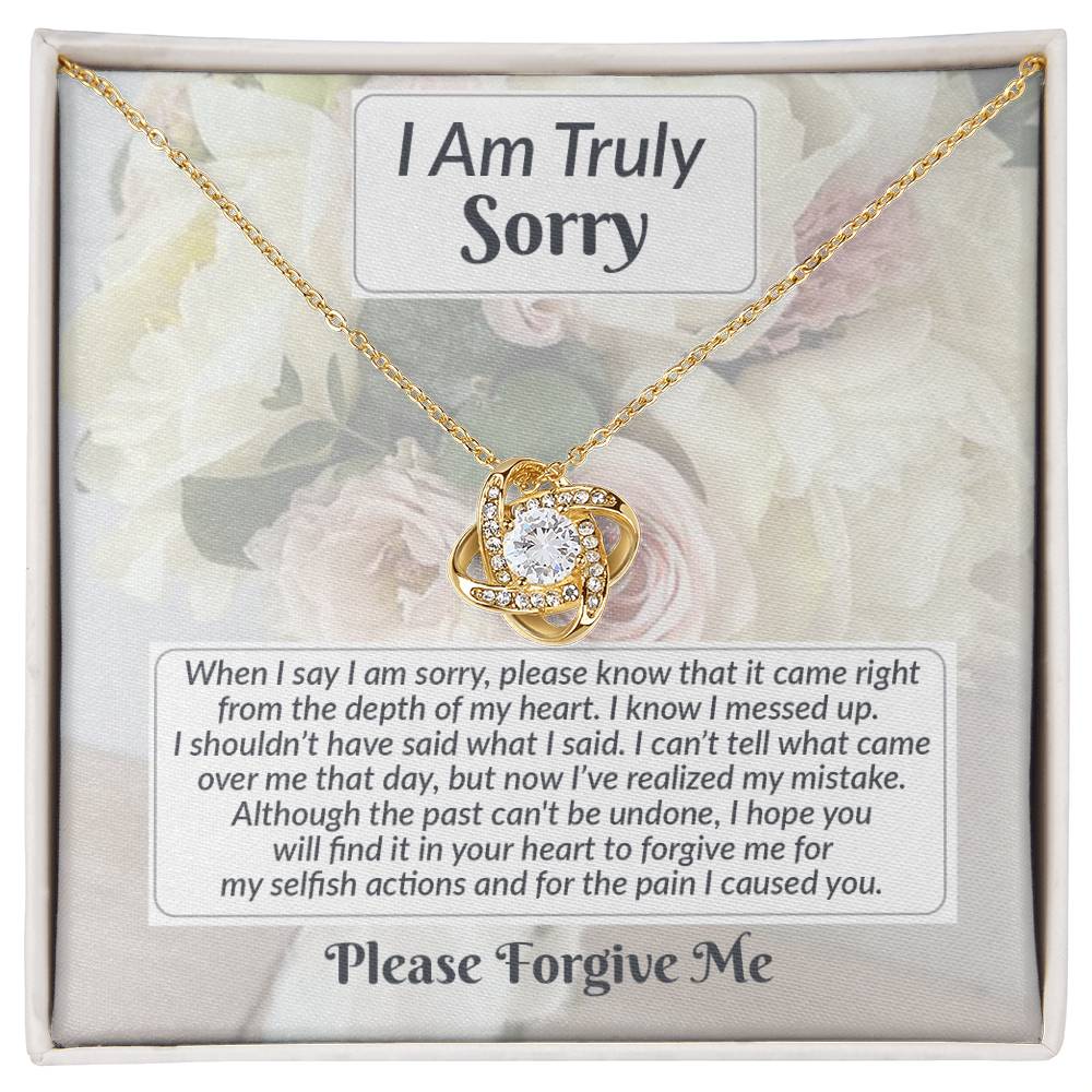 The Sorry-What I Said Love Knot Necklace, featuring a heart-shaped pendant adorned with cubic zirconia crystals, is elegantly presented in a box. The inner lid of the box displays a heartfelt apology message, expressing deep regret and asking for forgiveness. This personalized gift speaks volumes from the heart.