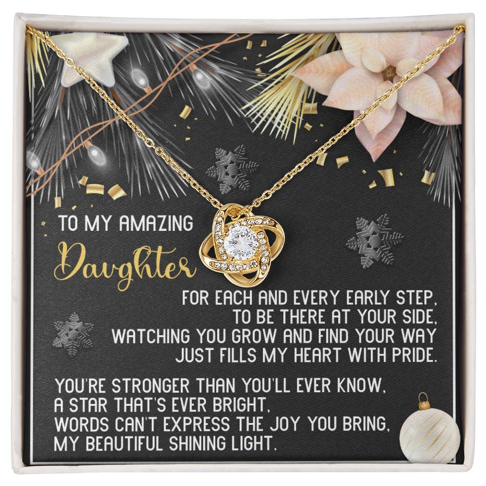 The Daughter-Shining Light - Love Knot Necklace, featuring a dazzling central gemstone surrounded by cubic zirconia crystals, is beautifully showcased on a card with an emotional message for your daughter, adorned with floral and decorative motifs. It's the ideal personalized gift to convey your steadfast love and affection.