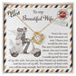 A 14k white gold To Wife, Be The One - Love Knot Necklace with cubic zirconia crystals is placed on a card depicting a couple on a scooter. The card features a heartfelt message to a wife, expressing love and commitment.