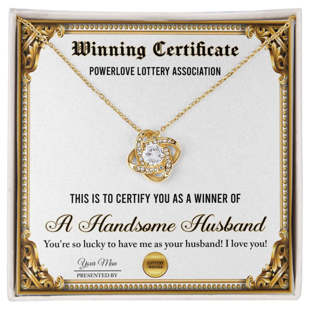 A "To Wife, Winning Certificate - Love Knot Necklace" is displayed against a certificate text background reading, "Winning Certificate - Powerlove Lottery Association - A Handsome Husband," featuring shimmering cubic zirconia crystals and an elegant gold finish.