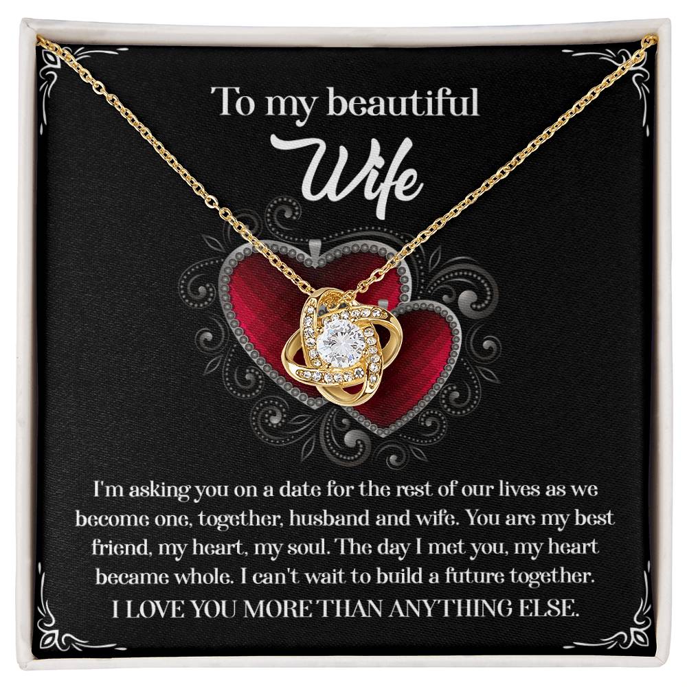 A To Wife, Heart Became Whole - Love Knot Necklace in a gift box, adorned with sparkling cubic zirconia crystals and accompanied by a heartfelt message for a wife, expressing love and a desire to build a future together.