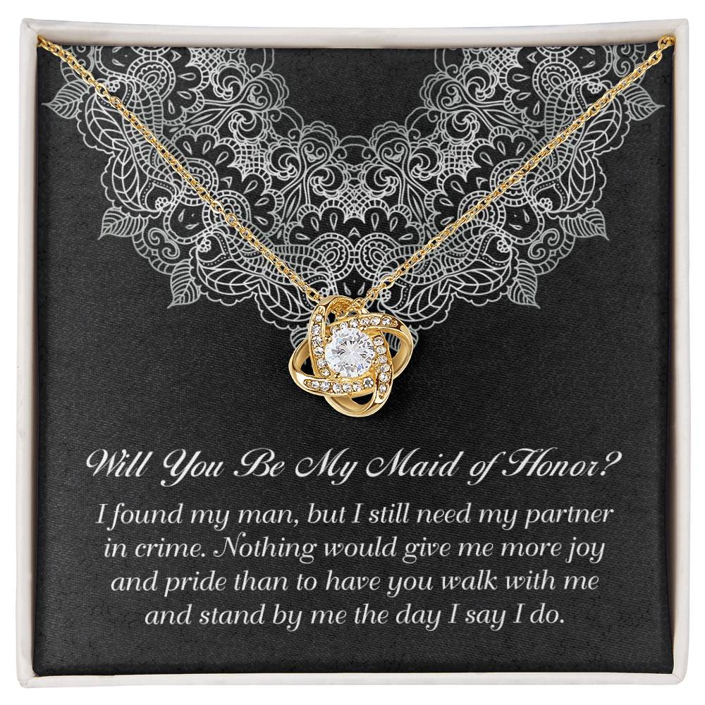 A decorative box with a "To Maid Of Honor, Partner In Crime - Love Knot Necklace" featuring a cubic zirconia; the text inside reads, "Will You Be My Maid of Honor?" followed by a heartfelt message.