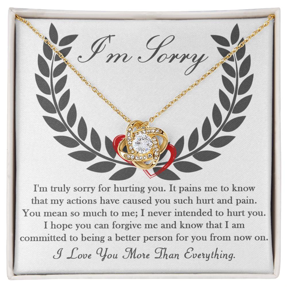 A 14k white gold "Sorry-From Now On - Love Knot Necklace," featuring a heart-shaped pendant adorned with cubic zirconia crystals, presented on a card with an apology message that reads: "I'm Sorry" followed by a heartfelt apology and commitment to change.