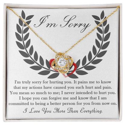 A 14k white gold "Sorry-From Now On - Love Knot Necklace," featuring a heart-shaped pendant adorned with cubic zirconia crystals, presented on a card with an apology message that reads: "I'm Sorry" followed by a heartfelt apology and commitment to change.
