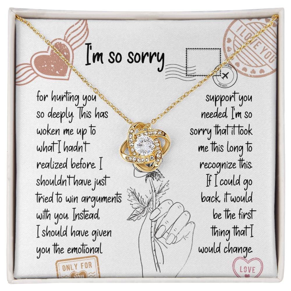 The Sorry-Emotional Support - Love Knot Necklace, featuring an intertwined knot pendant adorned with cubic zirconia crystals, is displayed on a card with an apology message expressing regrets and promising better emotional support in the future.