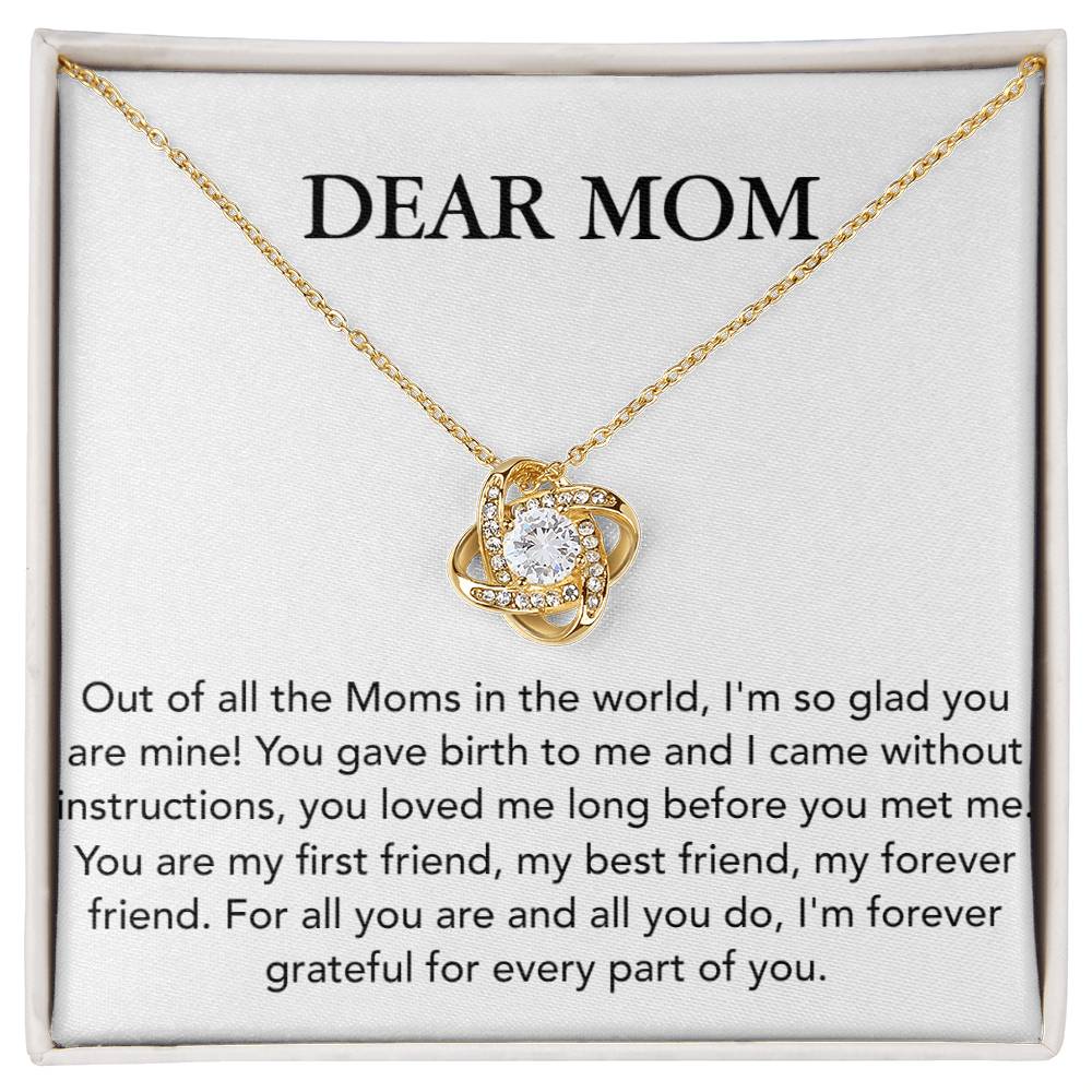 A white gold Love Knot Necklace with a heart pendant, presented on a card with a heartfelt message addressed to 'dear mom'. Dear Mom, Out of All The Moms In The World - Love Knot Necklace from ShineOn Fulfillment.