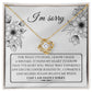 A "Sorry-Made A Mistake - Love Knot Necklace" features a box with a heartfelt apology message. The white gold finish and cubic zirconia crystals shimmer, as the text expresses deep regret and sorrow for causing hurt, describing the actions as pathetic, cowardly, and selfish, pleading for forgiveness.